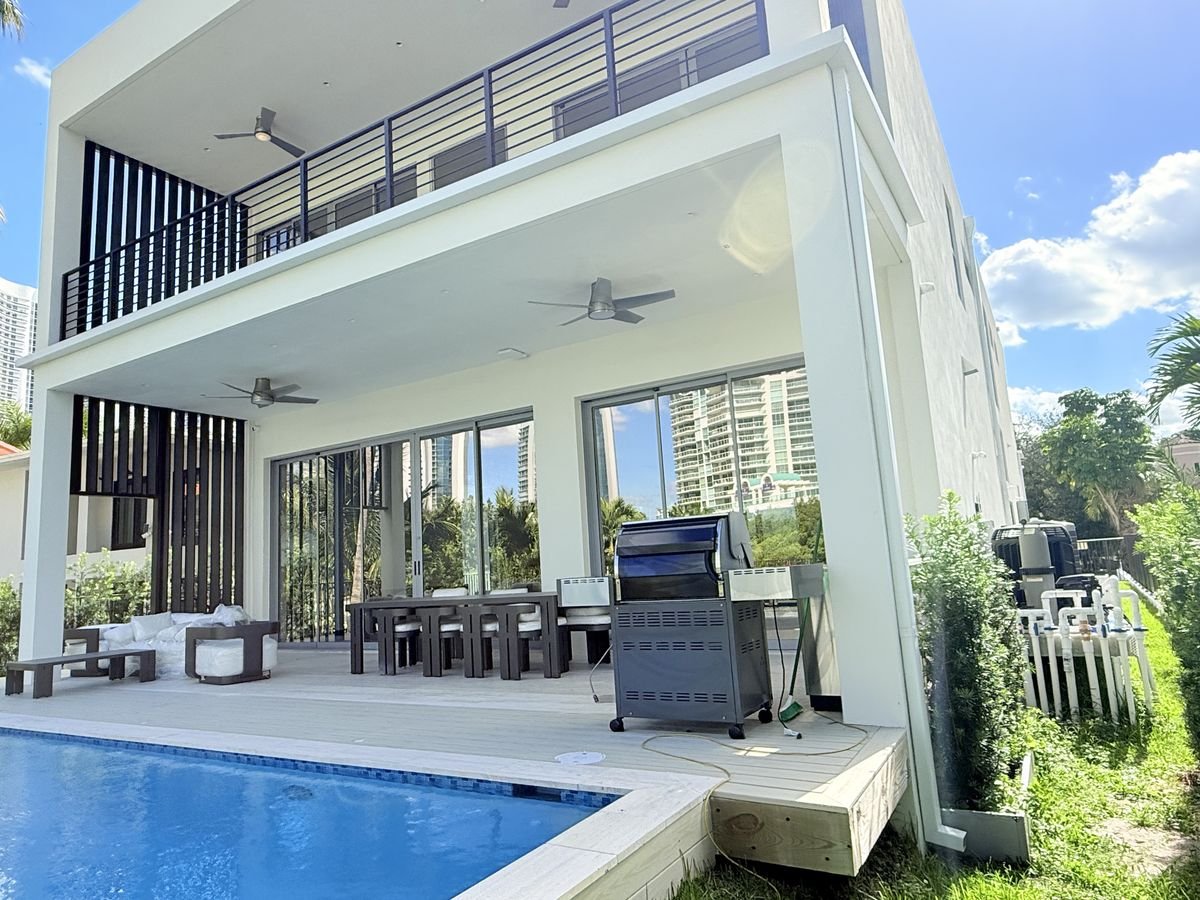 Seamless aluminum box gutter, color-matched white, on a modern Miami home — Emme Gutters