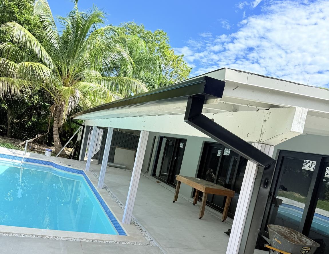 Seamless aluminum gutter and square downspout installed on a modern Miami home — Emme Gutters